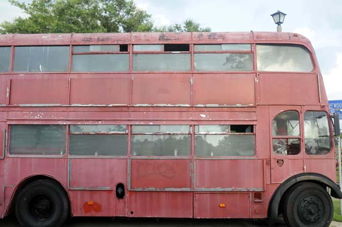 An antique bus remains parked outside for spectators to see Saturday, April 14, 2014 during the England vs Italy FIFA World Cup game screening at The Londoner Grill.