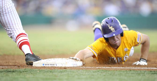 LSU sophomore infielder Alex Bregman (8) slides back into first base Monday, June 2, 2014 during the Tigers' 12-2 loss against Houston in Alex Box Stadium.