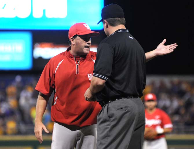 Houston head coach Todd Whitting argues with an umpire about a questionable call Sunday, June 1, 2014 during the Cougars' 5-4 victory against LSU in Alex Box Stadium.