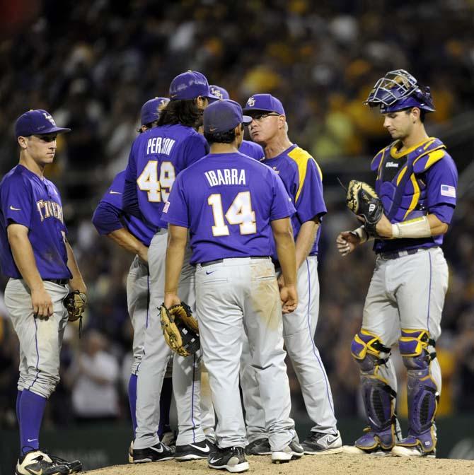 LSU team members huddle with head coach Paul Mainieri (1) Saturday, May 31, 2014 during Tigers' 5-1 victory against Houston in Alex Box Stadium.