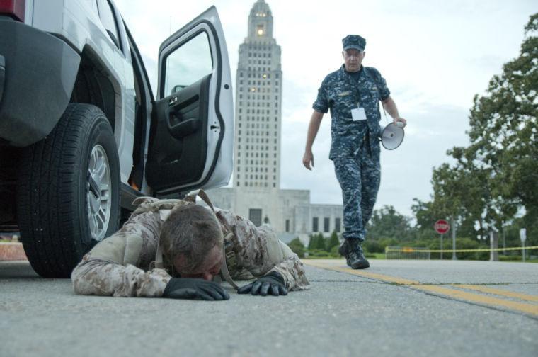 An actor lies on the ground near the starting line Saturday, June 28, 2014 before the post-apocalypse themed 5k race "Escape from Baton Rouge" near the Capitol building downtown.