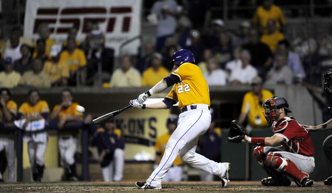 LSU junior catcher Kade Scivicque (22) hits the ball Sunday, April 1, 2014 during the Tigers' 5-4 loss against Houston in Alex Box Stadium.