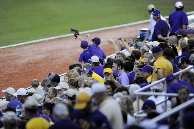 Fans reach out to catch the ball Saturday, May 31, 2014 during the Tigers' 5-1 victory against Houston in Alex Box Stadium.