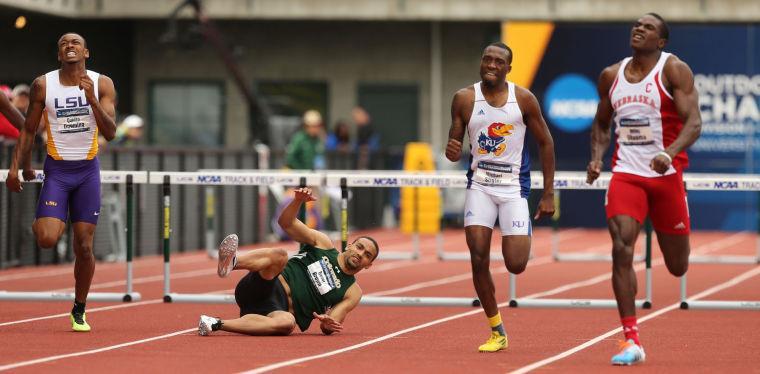 Quincy Downing, left, heads toward a third place finish as Trevor Brown, center, goes down, with Michael Stigler and Miles Ukaoma, right, continuing on to second and first place finishes respectively in the Men 400 meter hurdles at the NCAA Outdoor Track and Field Championships at Hayward Field in Eugene, Ore., Friday, June 13, 2014. (AP Photo/The Register-Guard, Chris Pietsch)