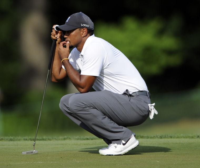 Tiger Woods waits on the 18th green during the second round of the Quicken Loans National golf tournament, Friday, June 27, 2014, in Bethesda, Md. Wood ended the day at 7-over-par 149 and missed the cut. (AP Photo/Nick Wass)