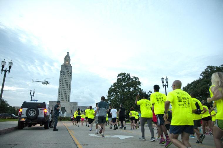 Race participants take off from the starting line Saturday, June 28, 2014 during the post-apocalypse themed 5k race "Escape from Baton Rouge" near the Capitol building downtown.