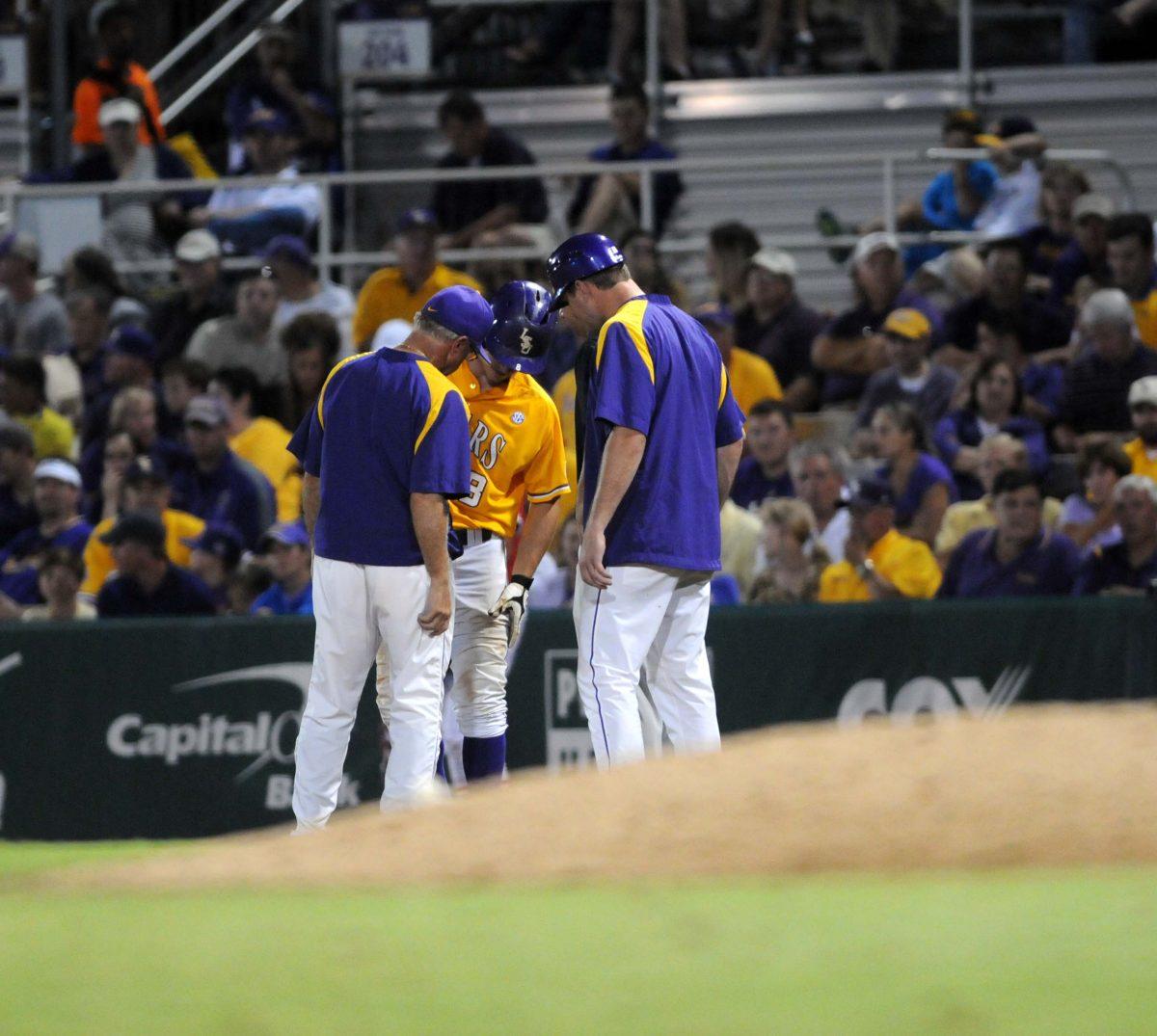 LSU sophomore outfielder Mark Laird (9) grabs the area of his leg where he was hit by the ball while batting Monday, April 2, 2014 during the Tigers' 12-2 loss against Houston in Alex Box Stadium.