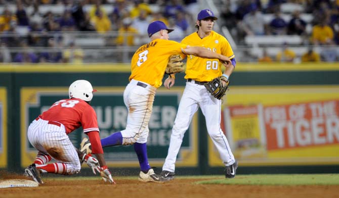 LSU sophomore infielder Alex Bregman (8) throws the ball towards first base after tagging Houston sophomore outfielder Ashford Fulmer (23) out at second base Monday, April 2, 2014 during the Tigers' 12-2 loss against the Cougars in Alex Box Stadium.