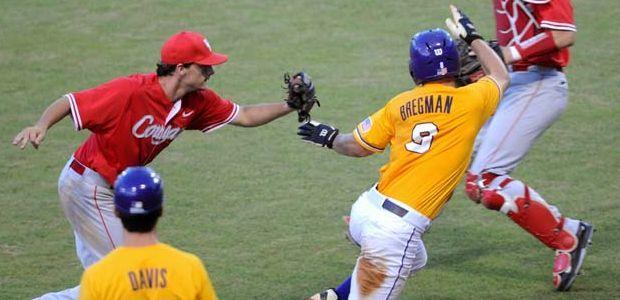 LSU sophomore infielder Alex Bregman (8) attempts to avoid being tagged out by a Houston third baseman Sunday, June 1, 2014 during the Tigers' 5-4 loss against the Cougars in Alex Box Stadium.