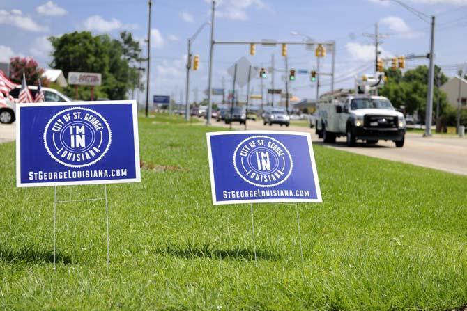 Signs encouraging citizens to sign a petition instituting the area of St. George as a city are arranged outside of Megan's Dress 2 the 9's Wednesday, June 18, 2014.