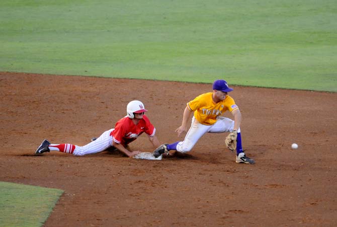 LSU sophomore infielder Alex Bregman (8) prepares to catch the ball as a Houston runner slides back to second base Monday, April 2, 2014 during the Tigers' 12-2 loss against the Cougars in Alex Box Stadium.