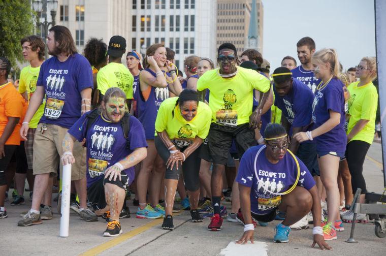 Race participants wait at the starting line Saturday, June 28, 2014 before the post-apocalypse themed 5k race "Escape from Baton Rouge" near the Capitol building downtown.