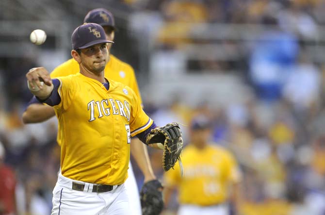 LSU junior infielder Tyler Moore (2) casually tosses the ball to first base Monday, June 2, 2014 during the Tigers' 12-2 loss against Houston in Alex Box Stadium.