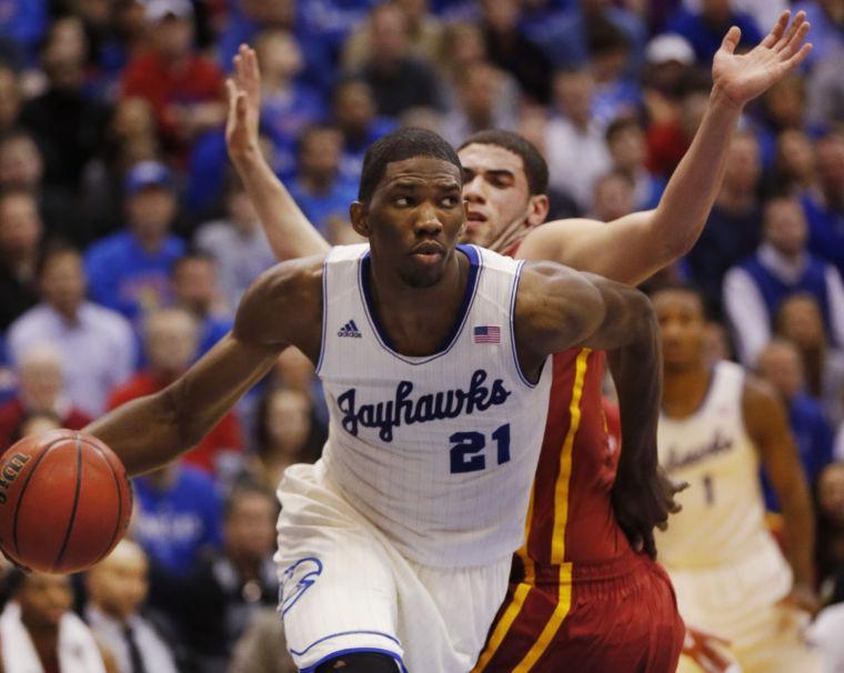 FILE - In this Jan. 29, 2014 file photo, Kansas center Joel Embiid (21) works around Iowa State forward Georges Niang, back, during the first half of an NCAA college basketball game in Lawrence, Kan. Embiid is a possible pick in the 2014 NBA Draft, Thursday, June 26, 2014 in New York.(AP Photo/Orlin Wagner, File)