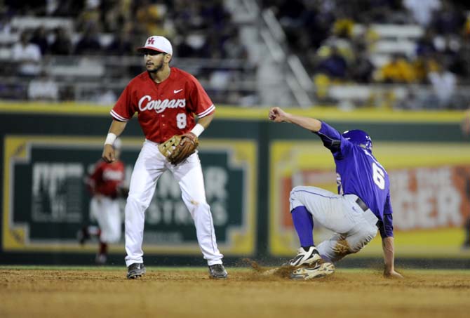 LSU sophomore outfielder Andrew Stevenson (6) slides to second base as Houston sophomore infielder Josh Vidales (8) looks towards the ball Saturday, May 31, 2014 during the Tigers' 5-1 victory against the Cougars in Alex Box Stadium.