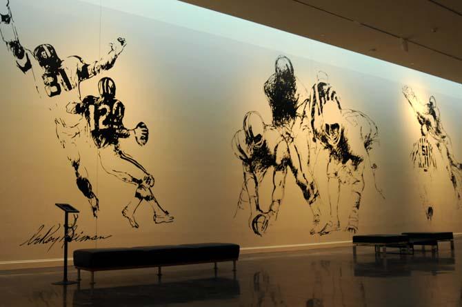 Sketches of football players displayed on the walls of the LSU Museum of Art for the "Leroy Neiman: Action" exhibit.