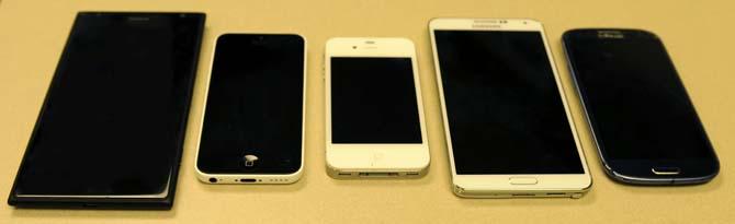 Pictured are the Nokia Lumia 1520 (left), iPhone 5c, iPhone 4, Samsung Galaxy Note 3 and Samsung Galaxy S3 (right).