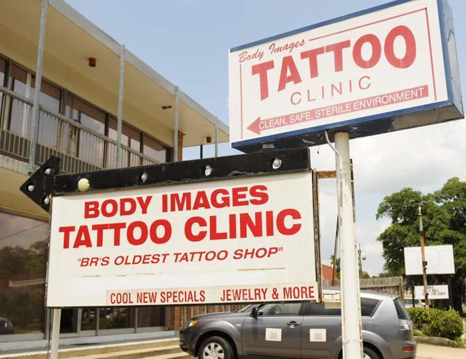 The signs displayed outside of Body Images Tattoo Clinic on 3607 Government St.