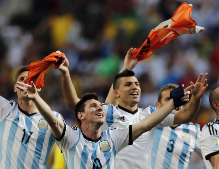 CORRECTS PHOTOGRAPHER'S BYLINE - Argentina's Lionel Messi and teammates celebrate at the end of the World Cup quarterfinal soccer match between Argentina and Belgium at the Estadio Nacional in Brasilia, Brazil, Saturday, July 5, 2014. Argentina won 1-0. (AP Photo/Eraldo Peres)