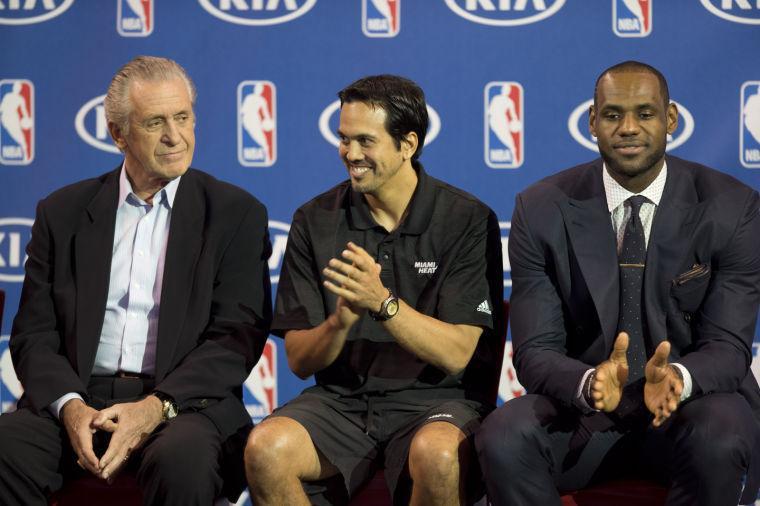 In this May 5, 2013 photo, Miami Heat team president Pat Riley, left, coach Erik Spoelstra, and LeBron James, right, poses in Miami after James won the NBA Most Valuable Player award. Before James makes his next decision, Riley will get a chance to convince him to stay in Miami. Two people familiar with the situation told The Associated Press late Sunday night, July 6, 2014, that James will meet with the Heat president this week before making a decision about where to play next season. (AP Photo/J Pat Carter)