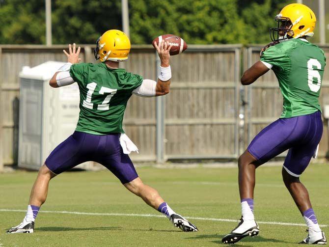 LSU freshman quarterbacks Brandon Harris (6) and Jared Foster (17) pass the ball to their receivers Tuesday, August 5, 2014 during a drill in the Charles McClendon Practice Facility.