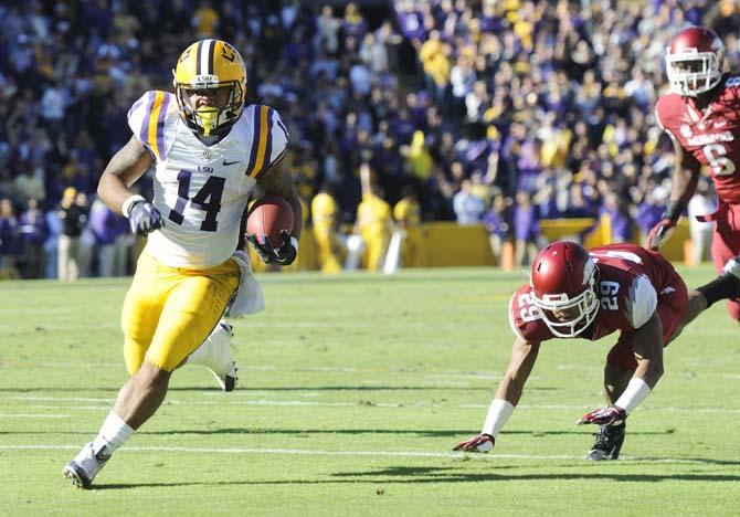 LSU junior running back Terrence Magee runs towards the endzone Friday, Nov. 29, 2013 during the Tigers' 31-27 victory at Tiger Stadium.