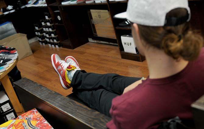 Local designer Hunter Hulin wears the Louisiana themed socks and shoes that he designed Wednesday August 20, 2014 at the Rukus Board Shop.