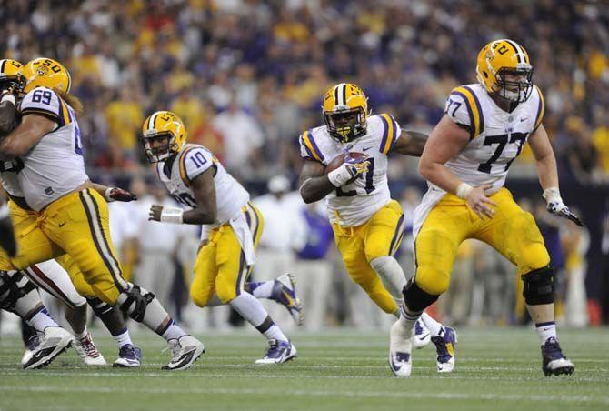 LSU senior running back Kenny Hilliard (27) drives downfield Saturday, August 30, 2014 during the Tigers' 28-24 victory against Wisconsin in the 2014 Advocare Texas Kickoff, held in the NRG Stadium in Houston, Texas.