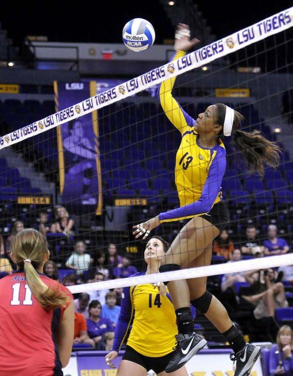 LSU freshman middle blocker Briana Holman (13) leaps up to spike the ball Friday, October 11, 2013 during the Tigers' victory against Ole Miss in the PMAC.