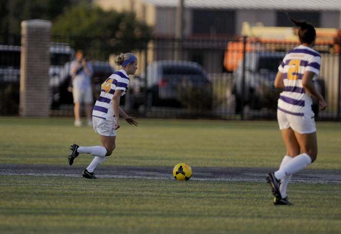 LSU senior midfielder Alex Arlitt (14) dribbles the ball Friday, August 22, 2014 during the Tigers' 2-0 victory against Troy in LSU Soccer Stadium.