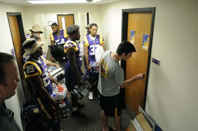 LSU footbal players assist freshman Grant Goodrum move into his dorm Wednseday August 20, 2014