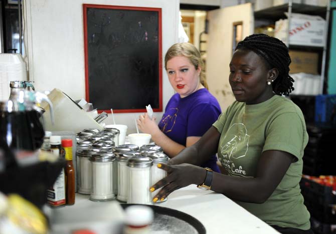 Waitress Dawn Simonson (left) sits with co-worker Jessica Poni (right) on Sunday, March 23, 2014 at Louie's Caf&#233;.