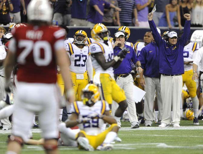 LSU head coach Les Miles celebrates after a turnover Saturday, August 30, 2014 during the Tigers' 28-24 victory against Wisconsin in the 2014 Advocare Texas Kickoff, held in the NRG Stadium in Houston, Texas.