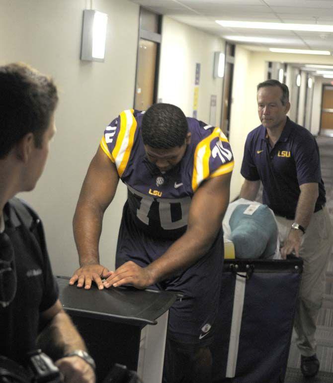 LSU senior offensive tackle La'el Collins (70) and LSU President F. King Alexander assist students move into their dorms Wednseday August 20, 2014 in West Hall.