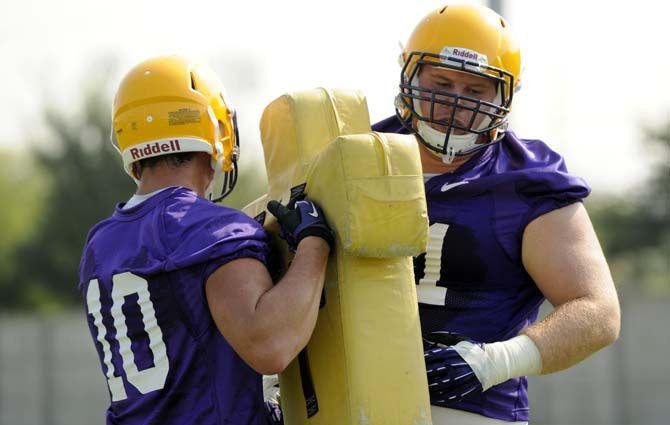 LSU sophomore defensive tackle Christian LaCouture (91) practices with freshman safety Austin Suits (10) Tuesday, August 5, 2014 during Fall Camp in the Charles McClendon Practice Facility.