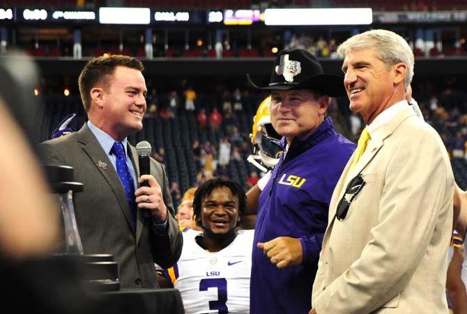 LSU head coach Les Miles sports a new hat Saturday, August 30, 2014 after the Tigers' 28-24 victory against Wisconsin in the 2014 Advocare Texas Kickoff, held in the NRG Stadium in Houston, Texas.