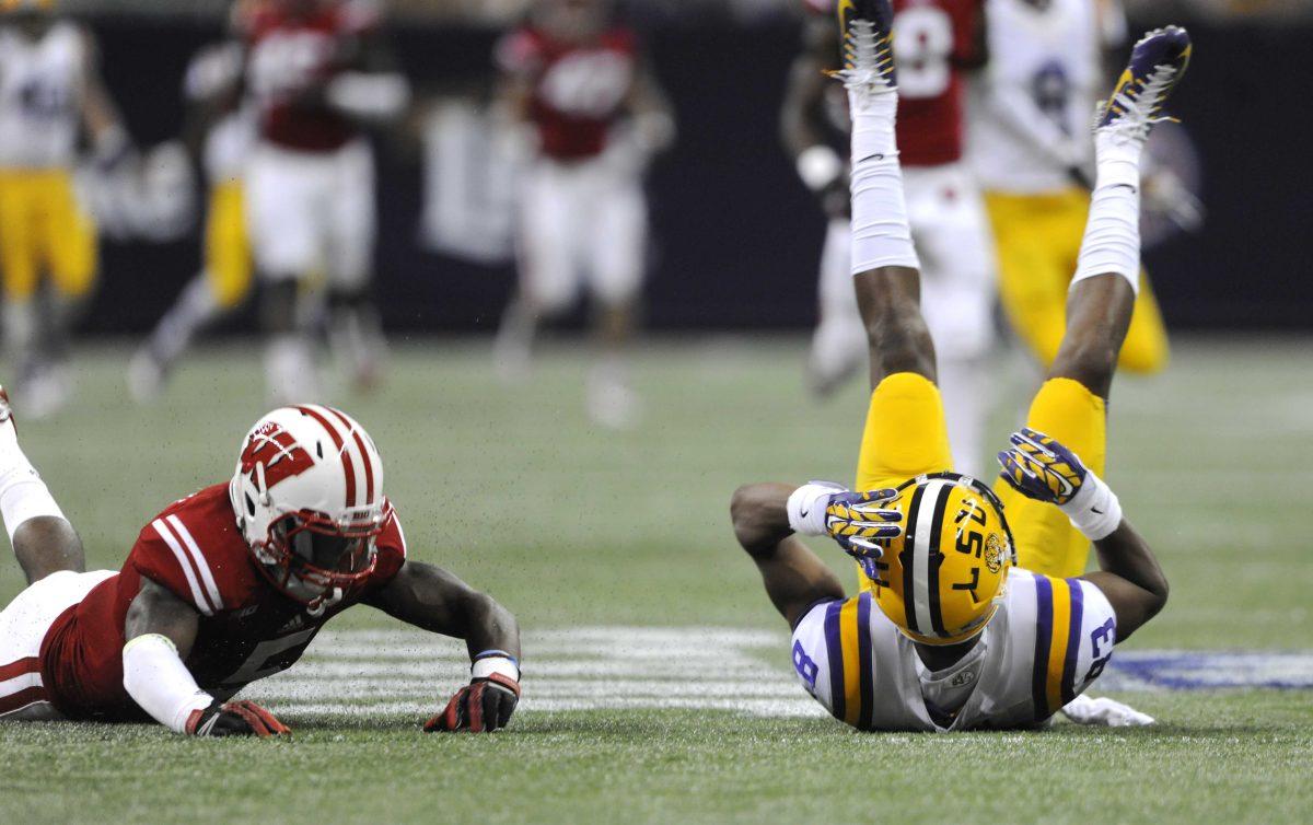 LSU sophomore wide receiver Travin Dural (83) slides on his back after missing a pass from sophomore quarterback Anthony Jennings Saturday, August 30, 2014 during the Tigers' game against Wisconsin in the 2014 Advocare Texas Kickoff, held in the NRG Stadium in Houston, Texas. Wisconsin leads LSU 17-7 at halftime.