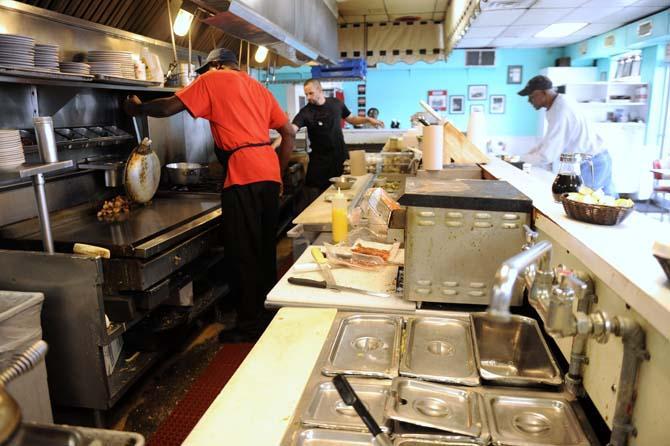 Fry cooks work in the kitchen Sunday, March 23, 2014 at Louie's Caf&#233;.