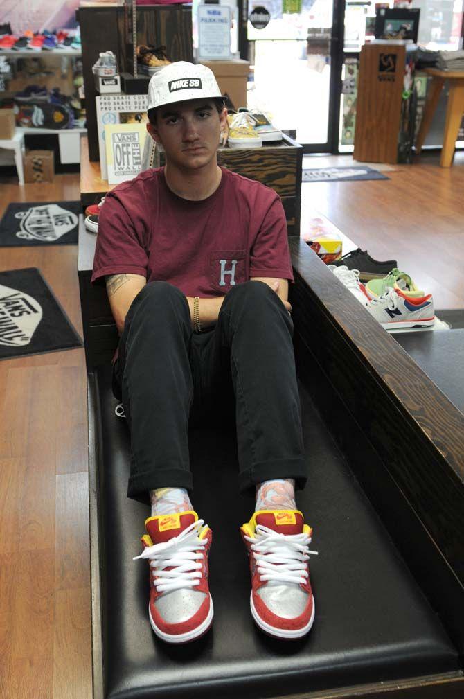 Local designer Hunter Hulin wears the Louisiana themed socks and shoes that he designed Wednesday August 20, 2014 at the Rukus Board Shop.