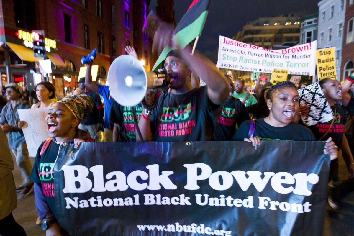 Demonstrators march through the streets in the Chinatown neighborhood of Washington, Saturday, Aug. 23, 2014, during a protest against the shooting of unarmed Michael Brown, a black 18-year-old killed by a white police officer in Ferguson, Mo. (AP Photo/Jose Luis Magana)