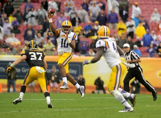 LSU freshman quarterback Anthony Jennings (10) throws to LSU senior running back Alfred Blue (4) on Wednesday, Jan. 1, 2014 during the Tigers' 21-14 victory against the Iowa Hawkeyes in the Outback Bowl at Raymond James Stadium in Tampa, Florida.