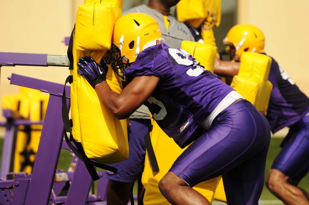 Members of the LSU football team practice tackling Tuesday, August 5, 2014 at the Charles McClendon Practice Facility.