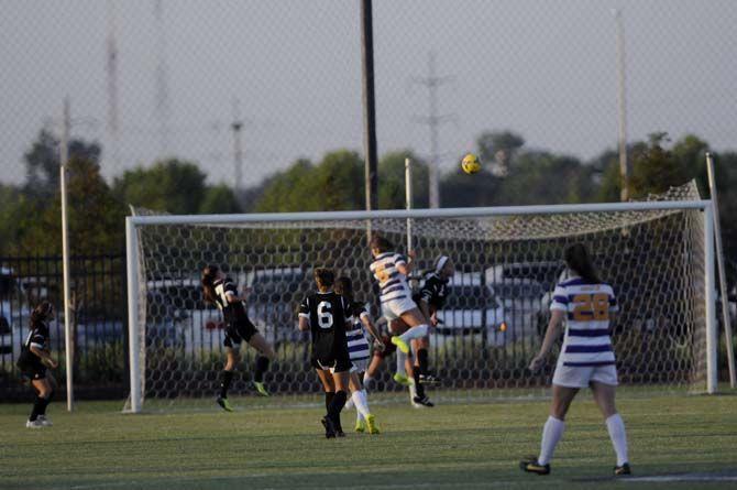 LSU freshman forward Jorian Baucom (5) heads the ball for the first Goal on Friday, August 22, 2014 during the Tigers' 2-0 victory against Troy in LSU Soccer Stadium.