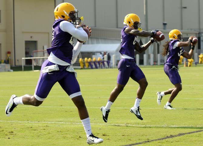 LSU football players run through catching drills Tuesday, August 5, 2014 during Fall Camp in the Charles McClendon Practice Facility.