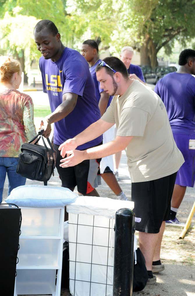 LSU basketball player John Odo assists a fellow student during move in day Wednesday August 20, 2014 at the Pentagon.