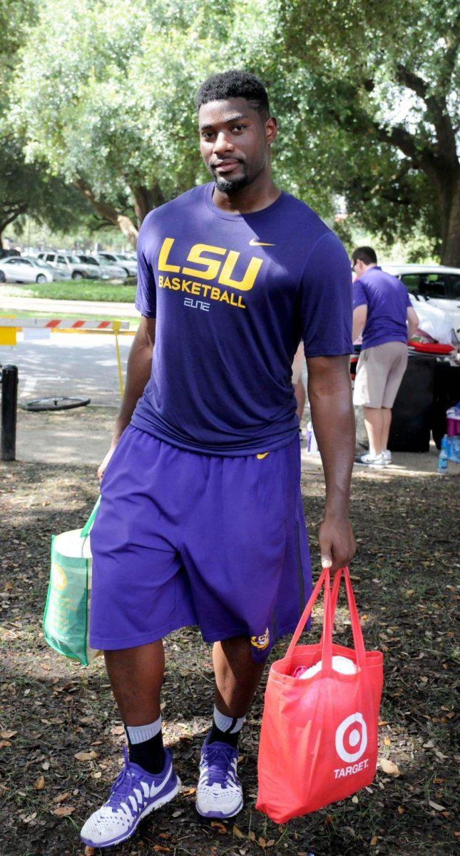 LSU basketball player Brian Bridgewater helps students with their belongins during move in day Wednesday August 20, 2014 at the Pentagon.