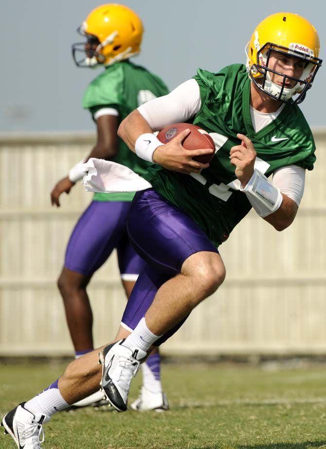 LSU junior quarterback Jared Foster (17) executes a running play Tuesday, August 5, 2014 during Fall Camp in the Charles McClendon Practice Facility.