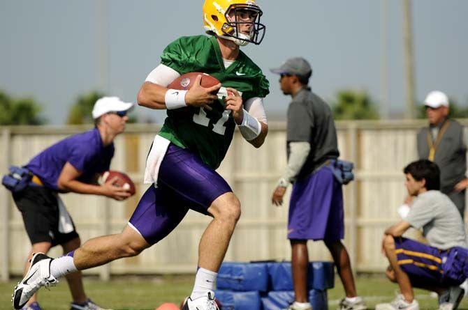 LSU junior quarterback Jared Foster (17) executes a running play Tuesday, August 5, 2014 during Fall Camp in the Charles McClendon Practice Facility.