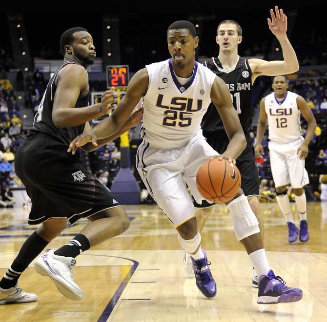 LSU freshman forward Jordan Mickey (25) moves past a Texas A&amp;M defender Wednesday, Feb. 26, 2014 during the Tigers' 68-49 victory against the Aggies in the PMAC.