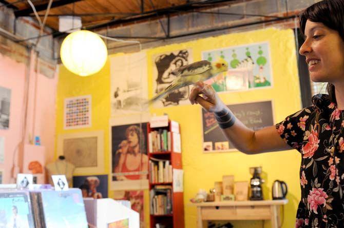 Lagniappe Records owner Tess Brunet plays with store mascot Agnes Thursday, August 21, 2014.